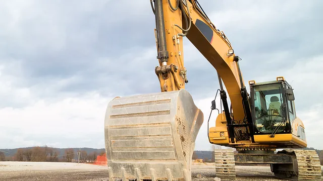 Excavator machinery ready to be used to move top soil